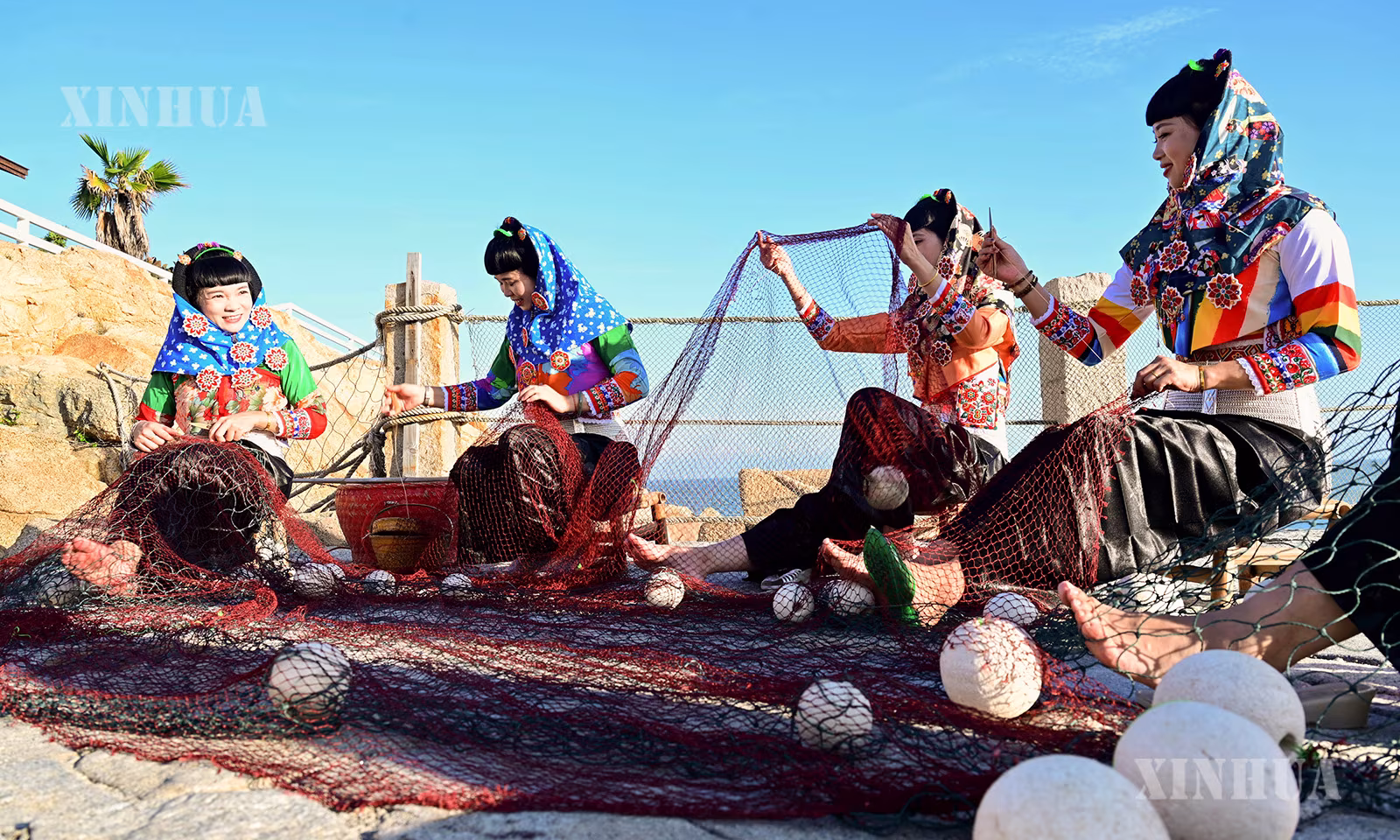 တရုတ်နိုင်ငံ ဖူကျန့်ပြည်နယ် ချွမ်ကျိုးမြို့ ဟွေ့အန်းခရိုင် ချုံဝူမြို့နယ် တာ့ကျော့ရွာရှိ ဟွေ့အန်းအမျိုးသမီး ဓလေ့ဥယျာဉ်တွင် ရက်လုပ်ထားသော ပိုက်ကွန်ကို ခရီးသွားဧည့်သည်များထံ ပြသနေသည့် ဖျော်ဖြေတင်ဆက်သူများကို ၂၀၂၆ ခုနှစ် ဩဂုတ် ၁၇ ရက်က တွေ့ရစဉ် (ဆင်ဟွာ)
